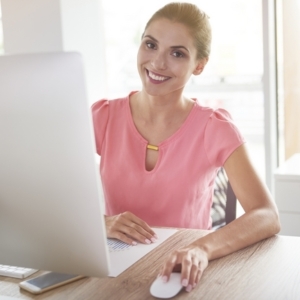 Portrait of woman in front of her computer